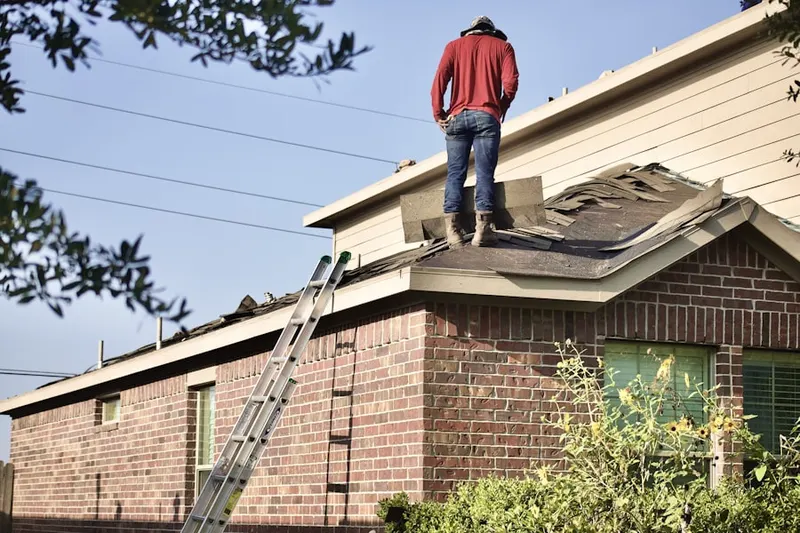 Professional roofer working on a residential roof in Beverly